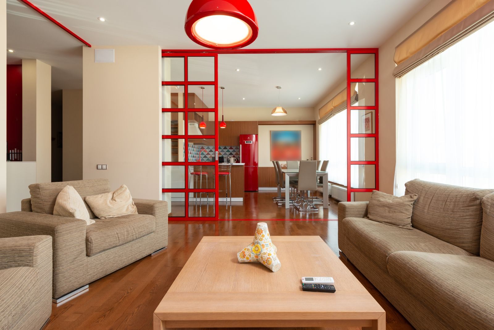 Comfortable sofa and armchair placed near table in living room in modern apartment in daytime